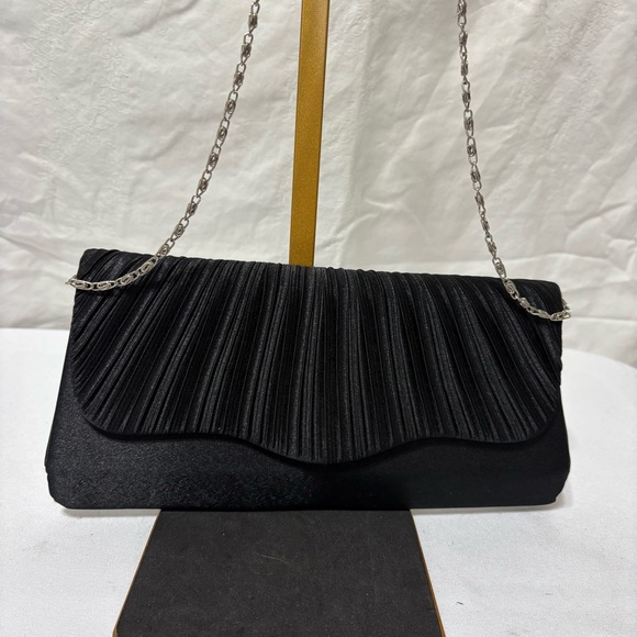 Handbags - black pleated evening clutch bag with a detachable silver-tone chain strap.